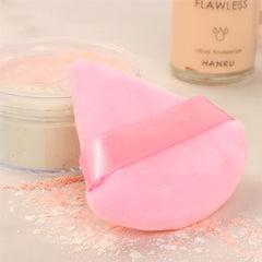 Ocim puff inside black and pink case for on-the-go makeup.