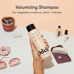 Odele Volumizing Shampoo bottle closeup shows clean, sulfate-free formula for sensitive scalps.