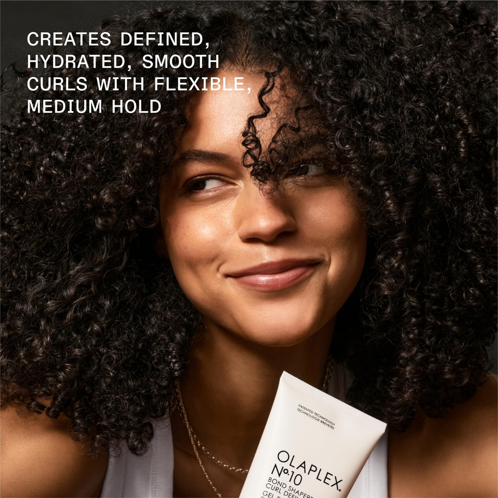 Olaplex No.10 bottle on damp hair highlights humidity resistance and smoothness.