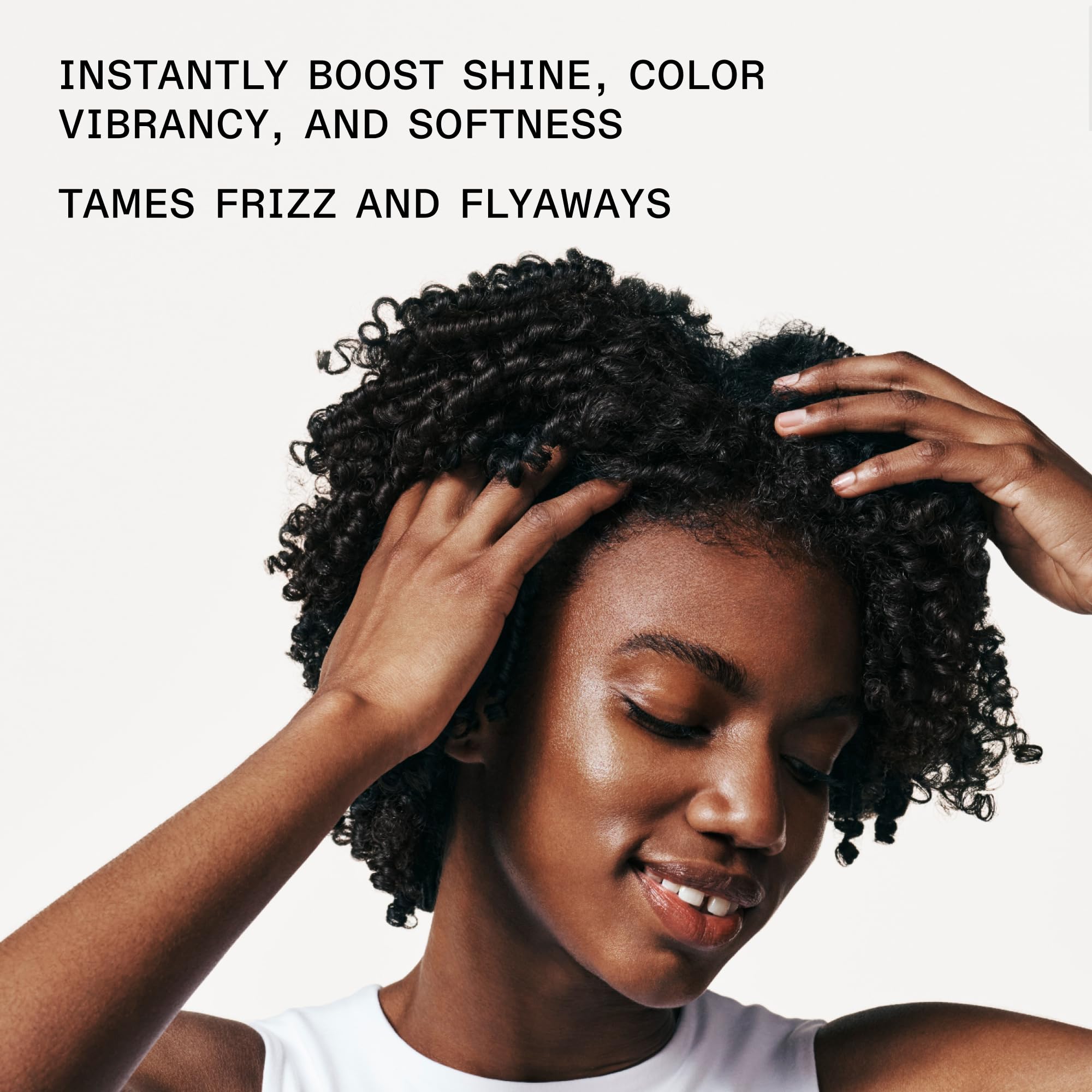 Olaplex No. 7 Bonding Oil on glossy hair showcases frizz control and smoothness.
