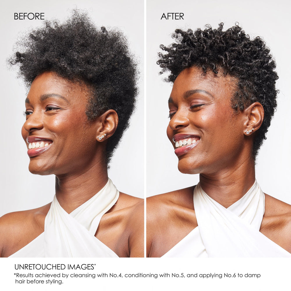 Hands detangling glossy hair with Olaplex No. 5 conditioner texture.