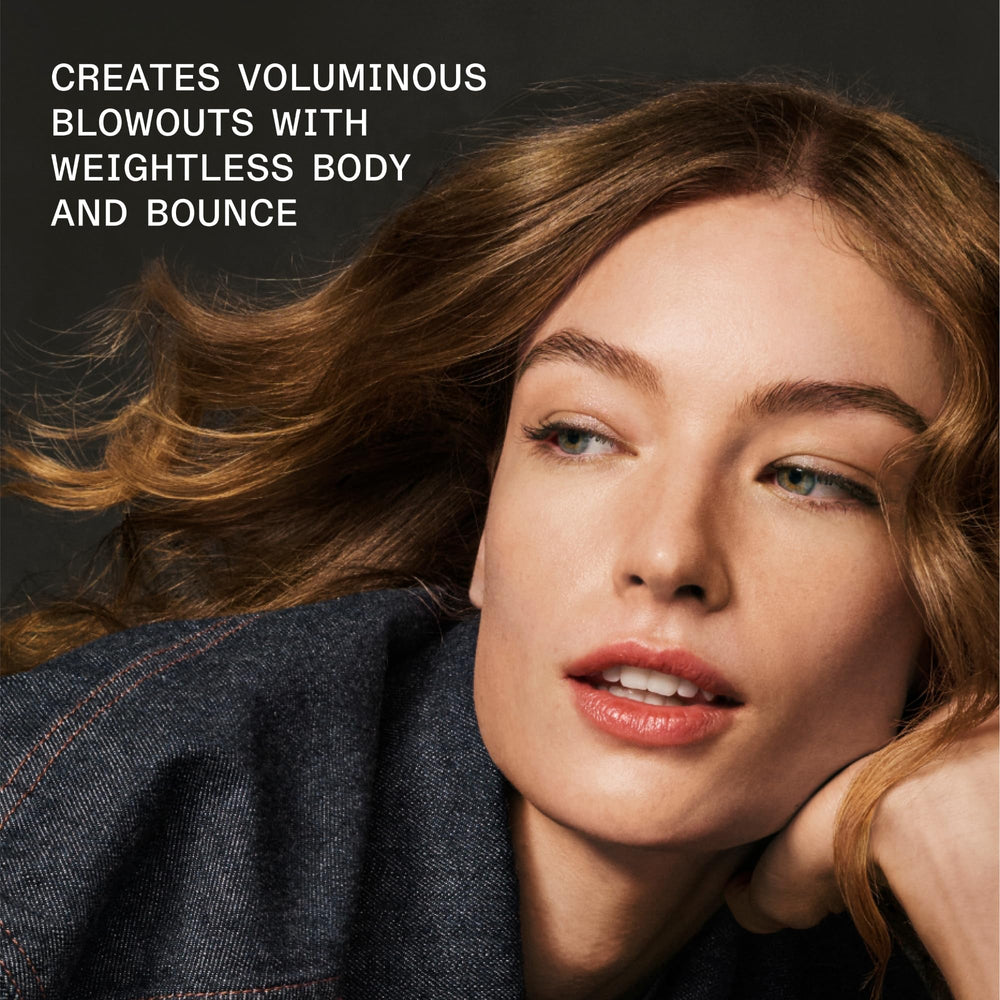 Olaplex Volumizing Blow Dry Mist applied to hair for smooth texture and heat protection