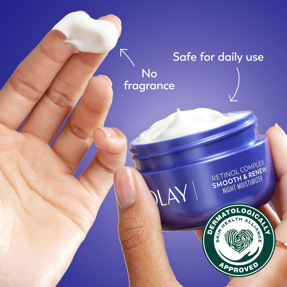 Olay cream texture being applied with fingertip in dim, calm bedroom