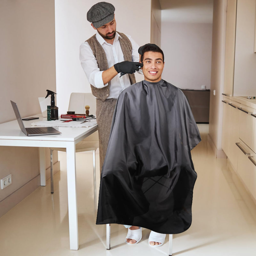 Omvoina waterproof cape protects clothing during dyeing, perms, and styling.
