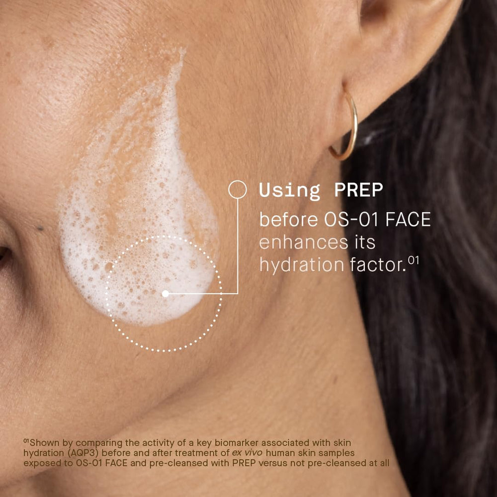 Hands massaging OneSkin PREP onto damp face during routine