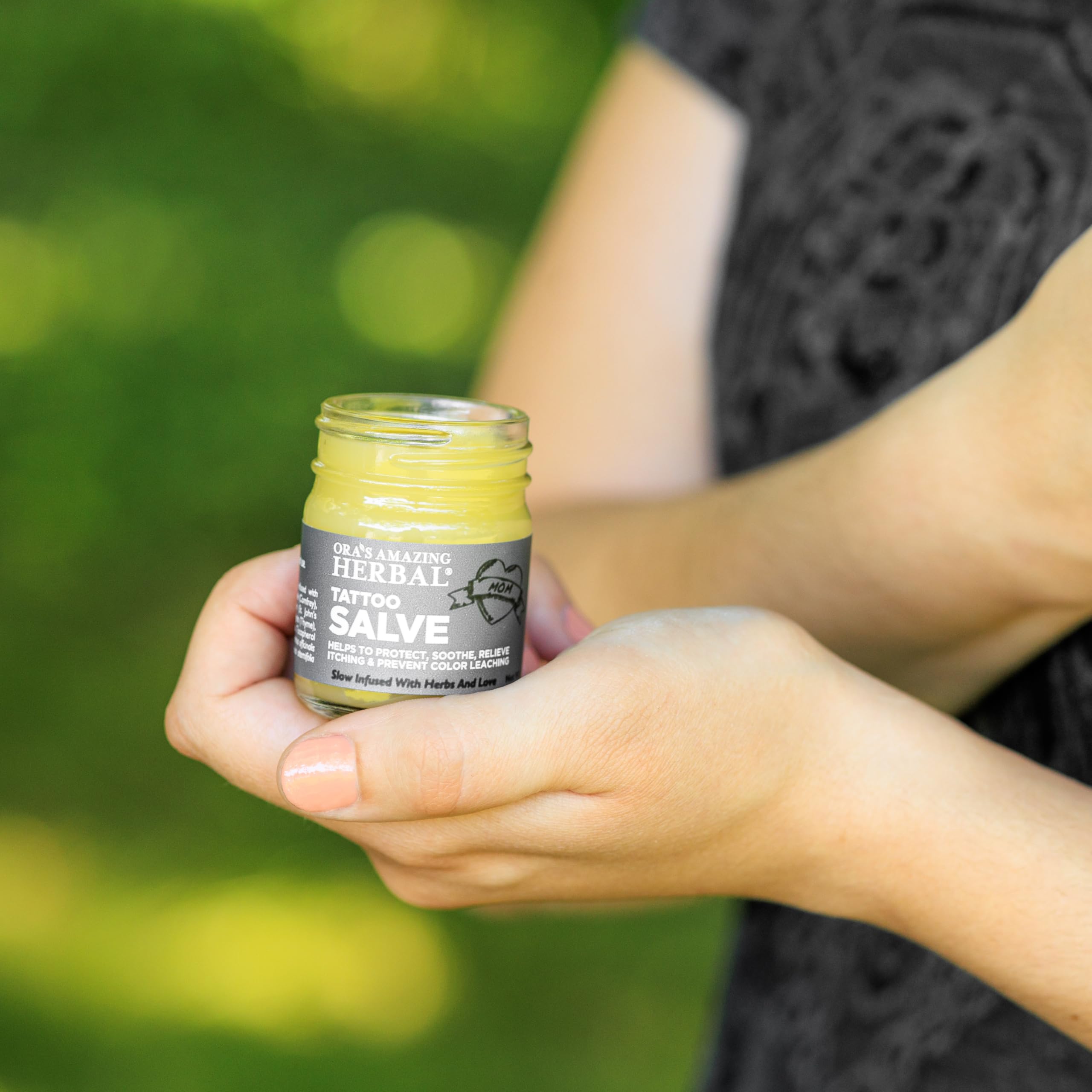 Ora's Amazing Herbal Tattoo Salve glass jar showcasing quality packaging