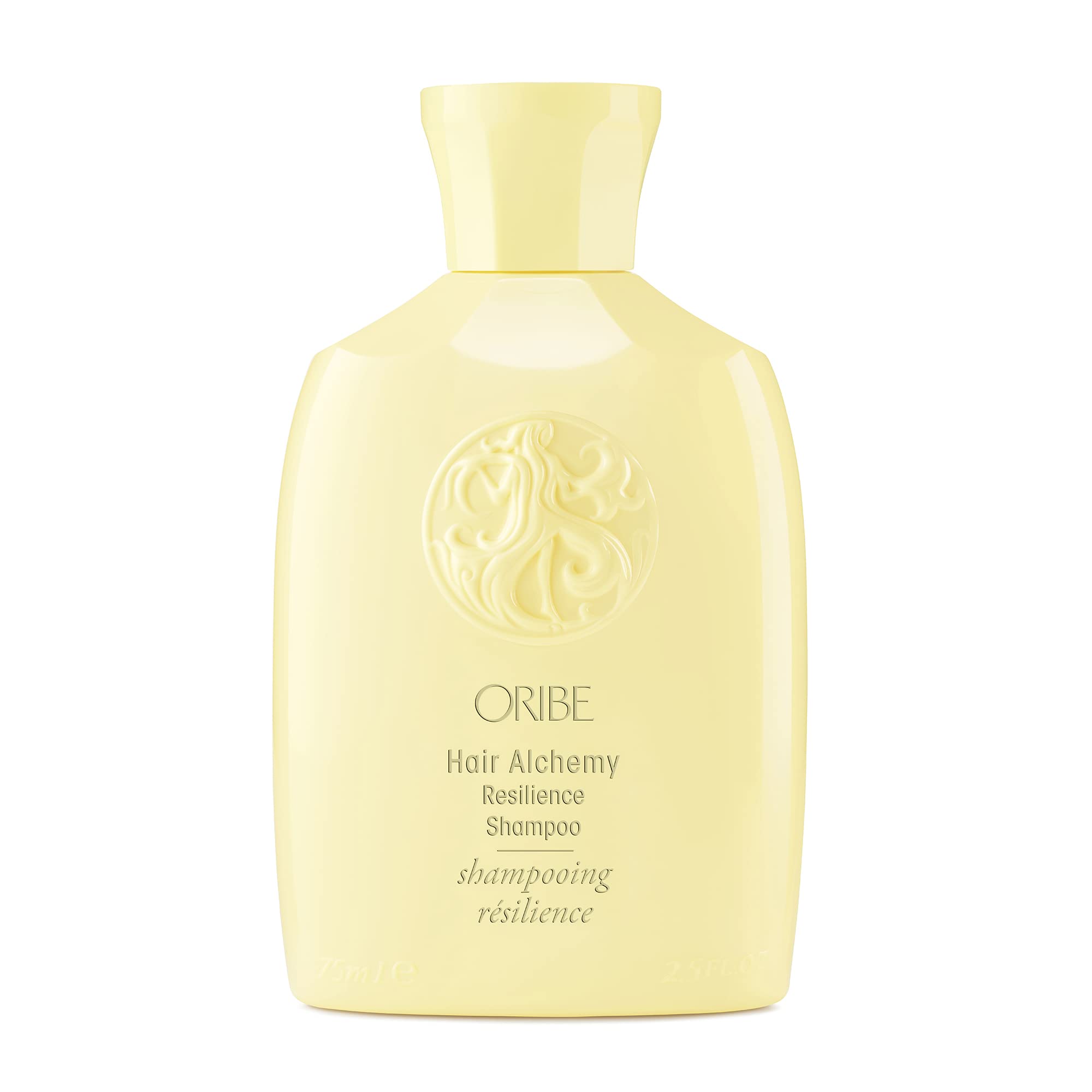 Oribe Alchemy Resilience Champú, botella vertiendo, limpieza suave y fortalecimiento del cabello.