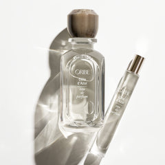 Oribe Côte d'Azur bottle close-up emphasizes unisex appeal and Riviera-inspired scent.