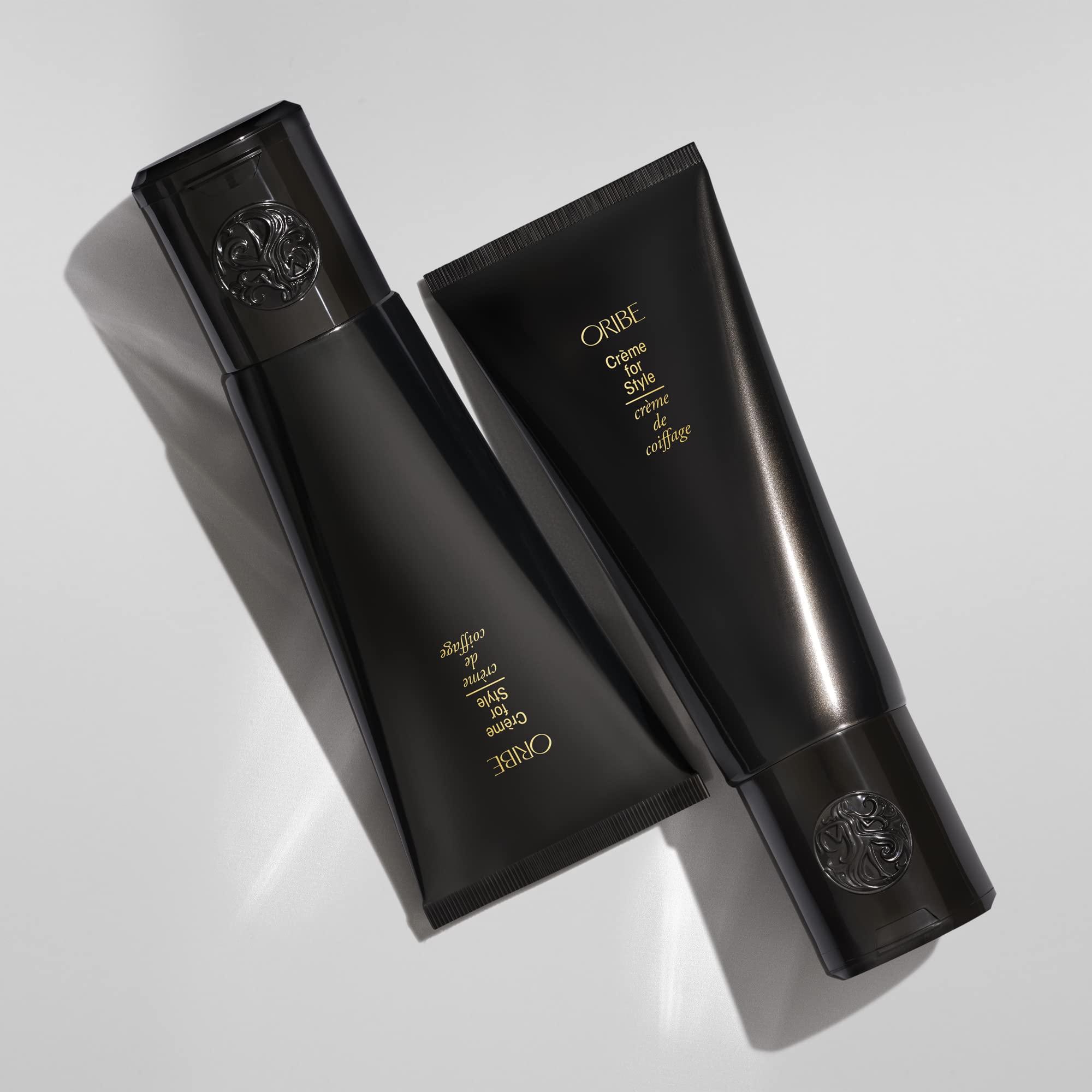 Oribe Crème for Style dispenser demonstrates easy application for frizz control.