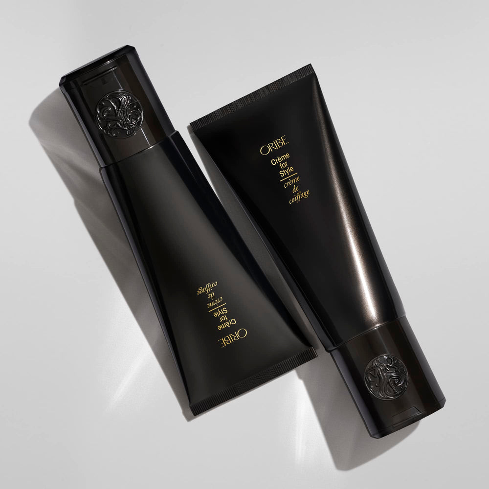 Oribe Crème for Style dispenser demonstrates easy application for frizz control.