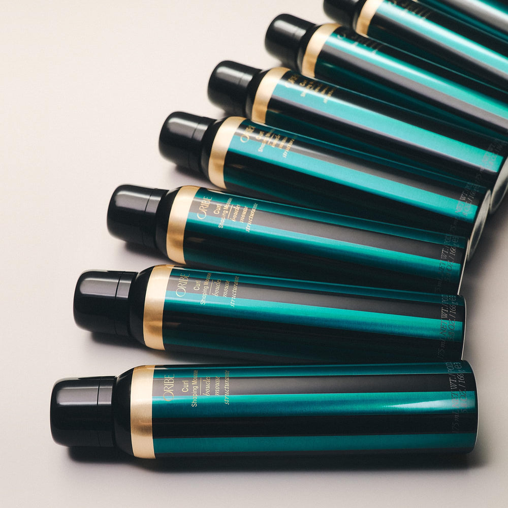 Oribe Curl Shaping Mousse on hair with defined curls and bounce.