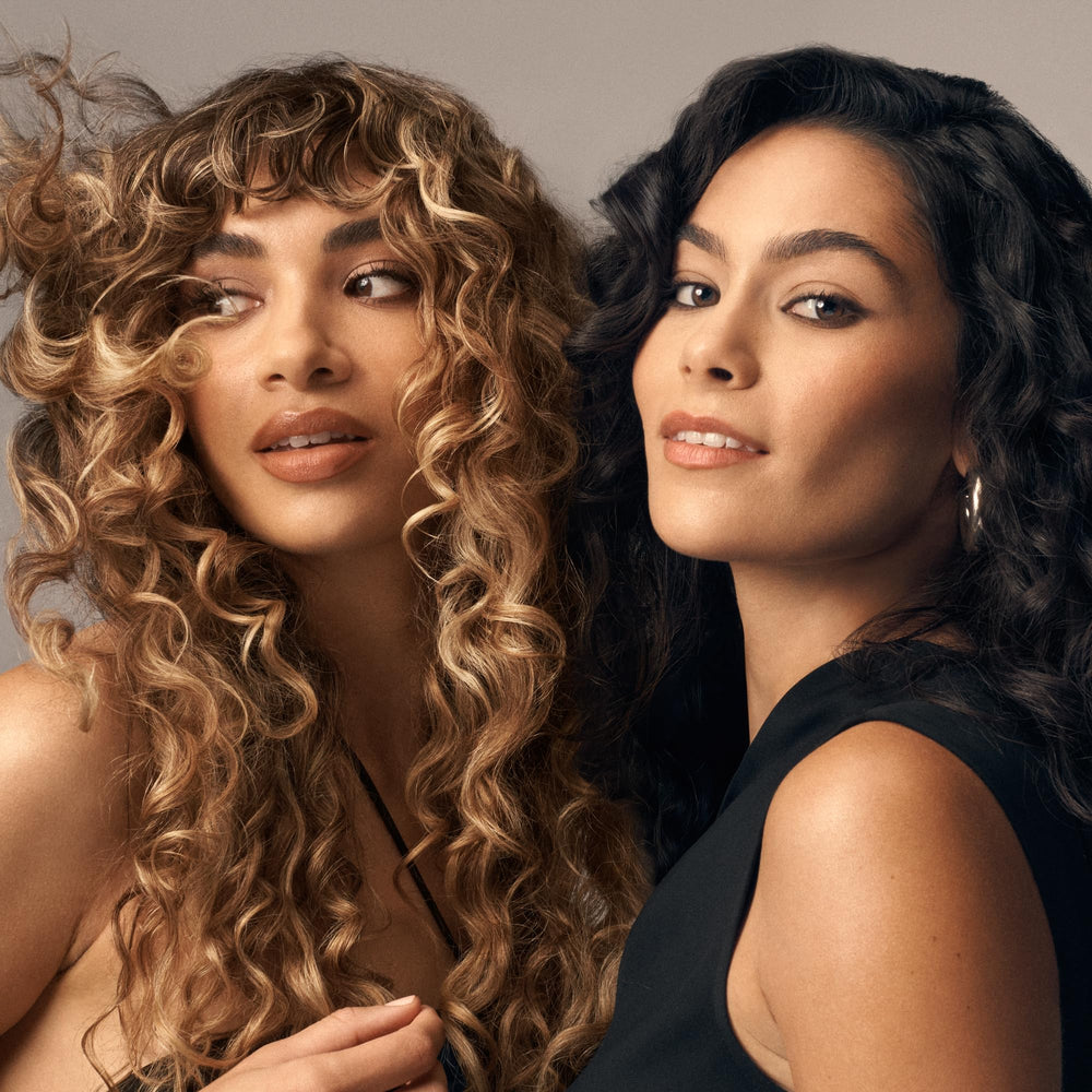 Oribe Curl Shaping Mousse bottle close-up with premium packaging.