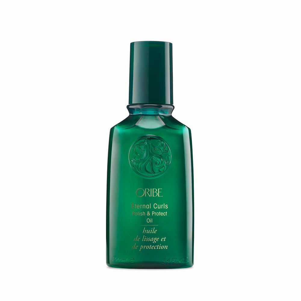 Oribe Eternal Curls Polish & Protect Oil bottle on vanity highlights frizz control and shine.