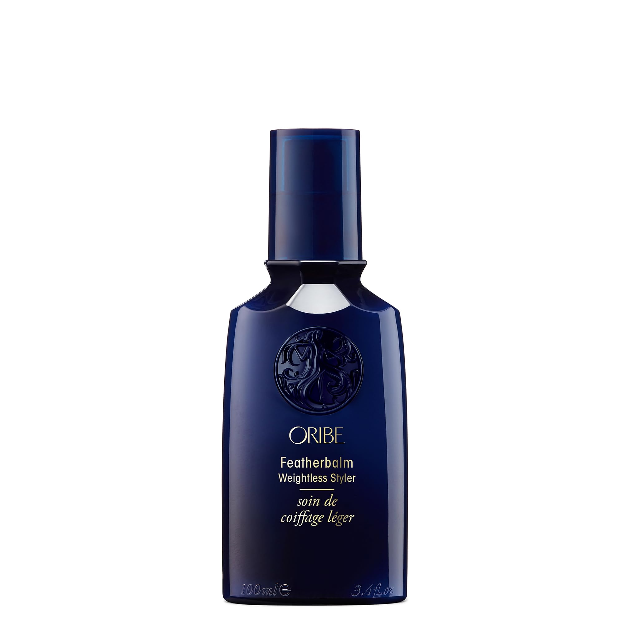 Oribe Feather Balm Ultra Light Bottle showcases weightless shine for fine hair.