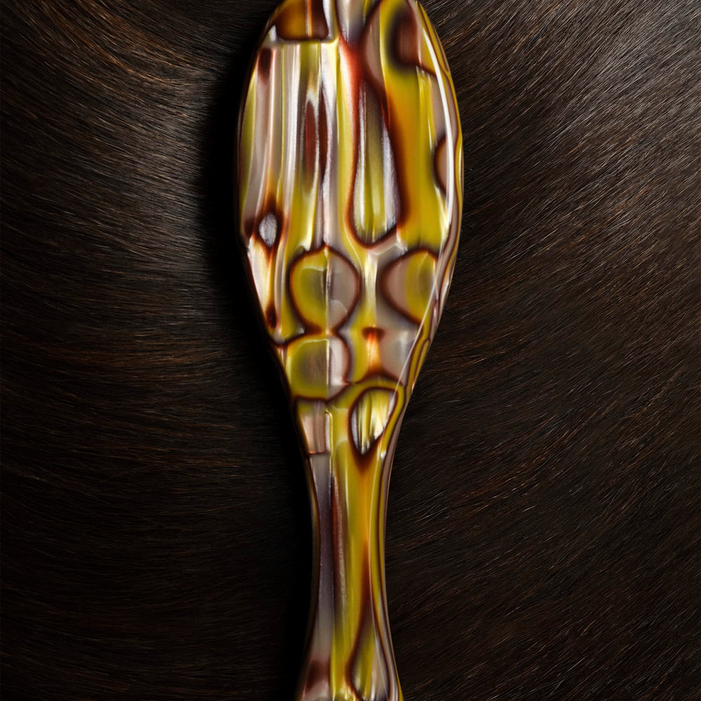 Oribe Flat Brush in action delivering a smooth, polished finish.