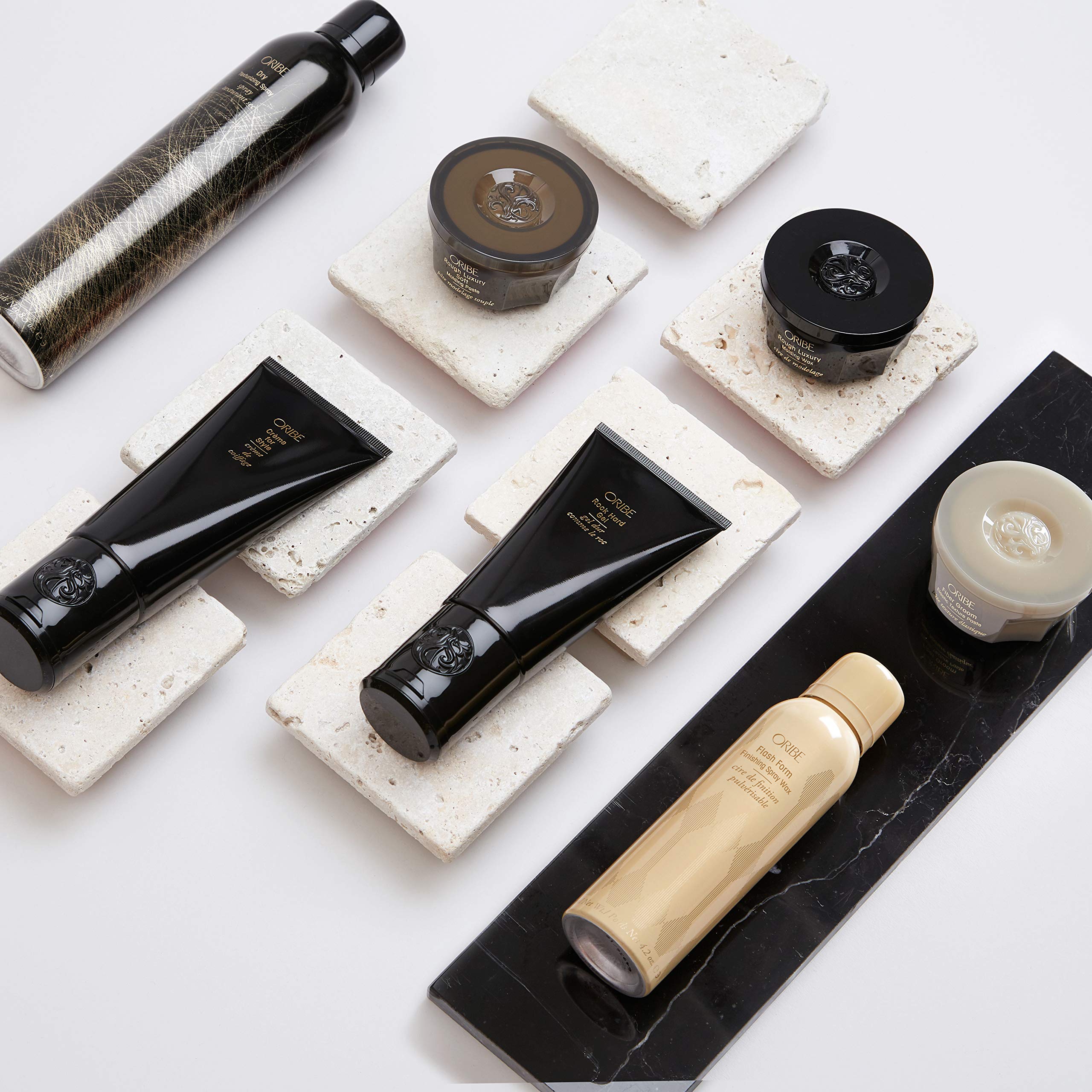 Oribe Gel Radiance Magic and Hold Serum application on hands for smooth, controlled styling.