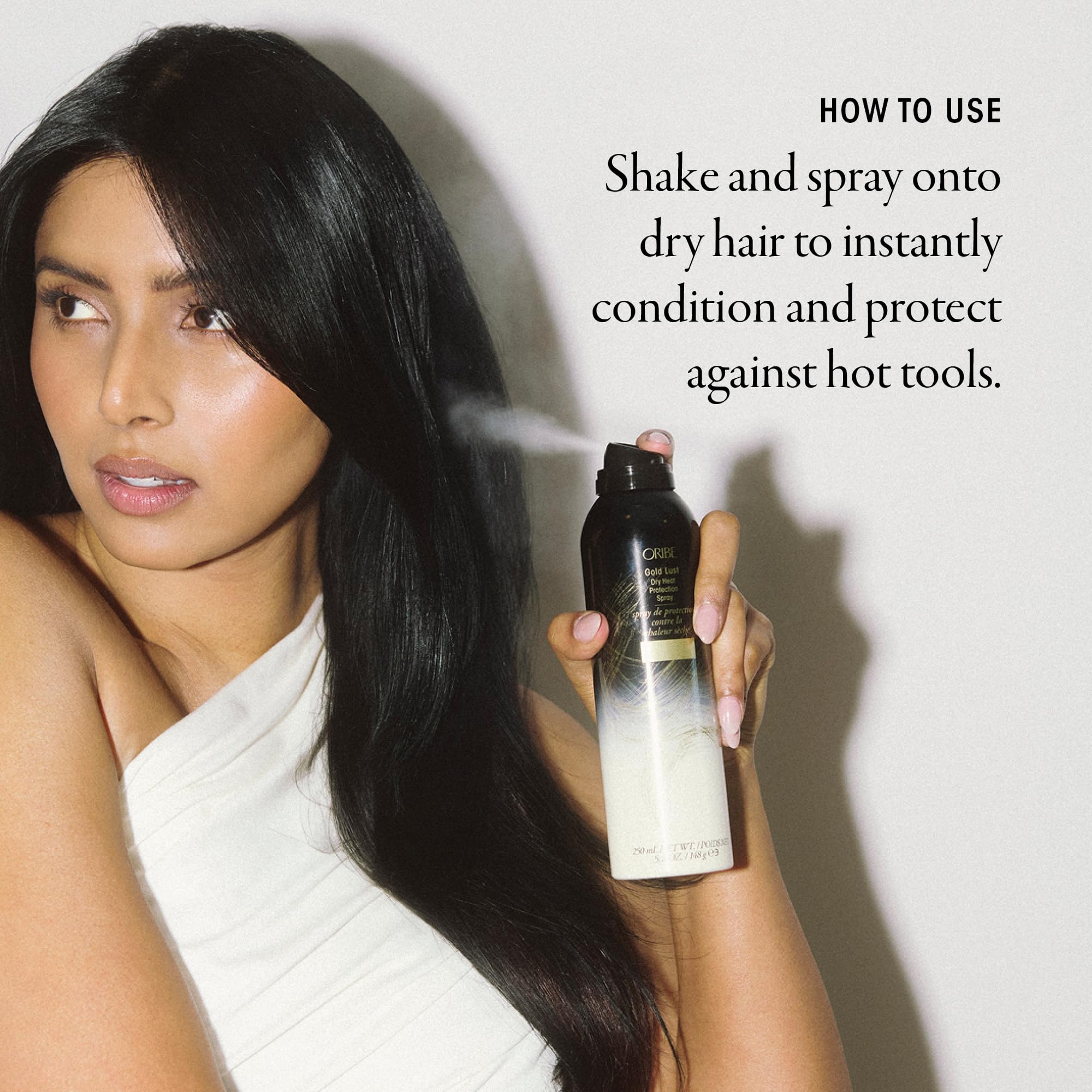 Oribe Gold Lust shield on strands during heat styling protects against tool stress