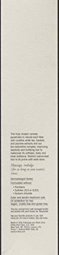Applying Oribe Masque to mid-length hair for fortification and elasticity.