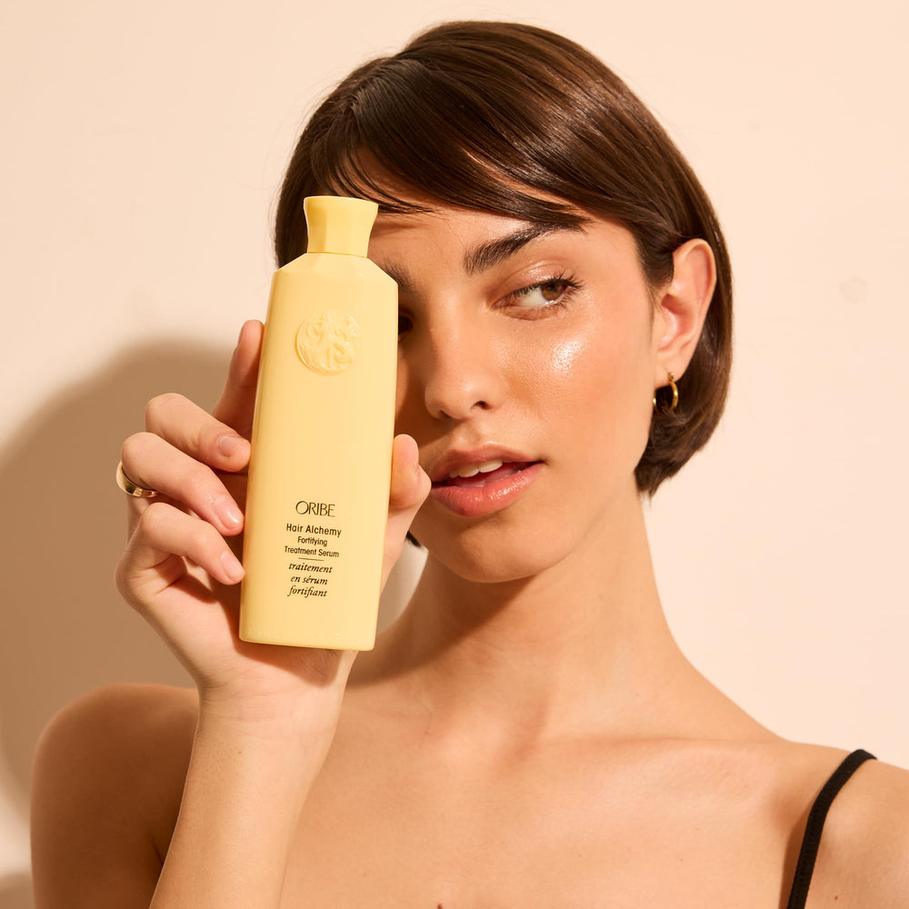 Oribe Hair Alchemy Fortifying Treatment applied to wet hair shows quick absorption