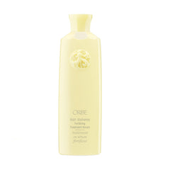 Oribe Hair Alchemy Fortifying Treatment bottle close-up showing conditioning serum for fragile hair