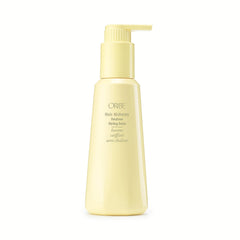 Oribe Hair Alchemy Balm bottle on display emphasizes premium heatless styling