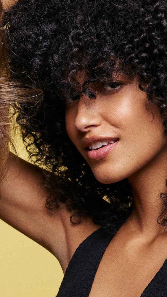 Oribe Hair Alchemy Resilience Shampoo packaging features daisy and honeysuckle-inspired scent.