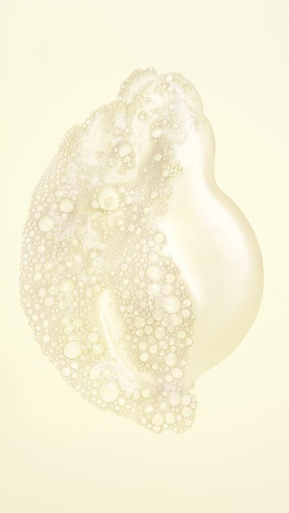 Oribe Hair Alchemy Resilience Shampoo lather close-up shows nourishing, strand-strengthening formula.