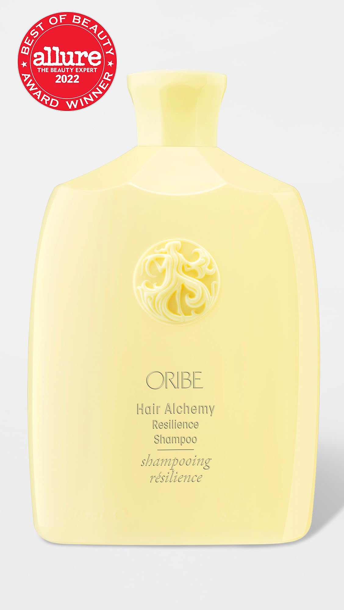 Oribe Hair Alchemy Resilience Shampoo pump releasing a rich lather for gentle cleansing.