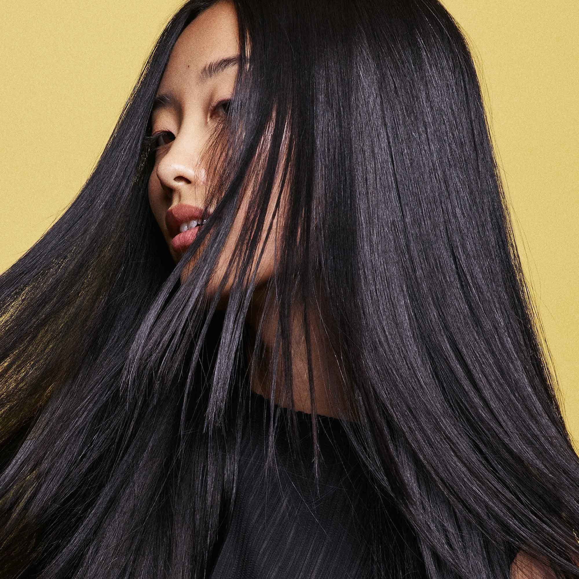Oribe Hair Alchemy Serum bottle front shows targeted fortification for breakage-prone hair.