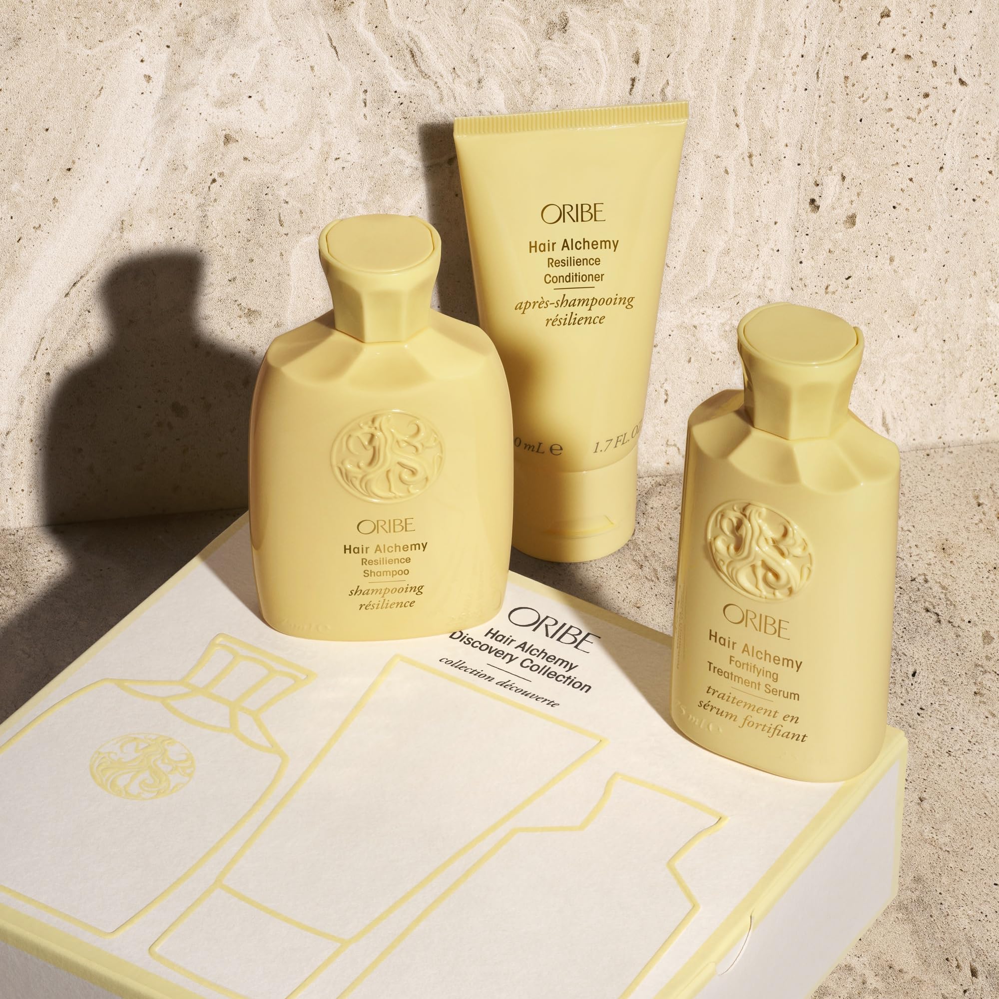 Oribe Hair Alchemy Fortifying Treatment Serum travel bottle front reinforces fragile hair.