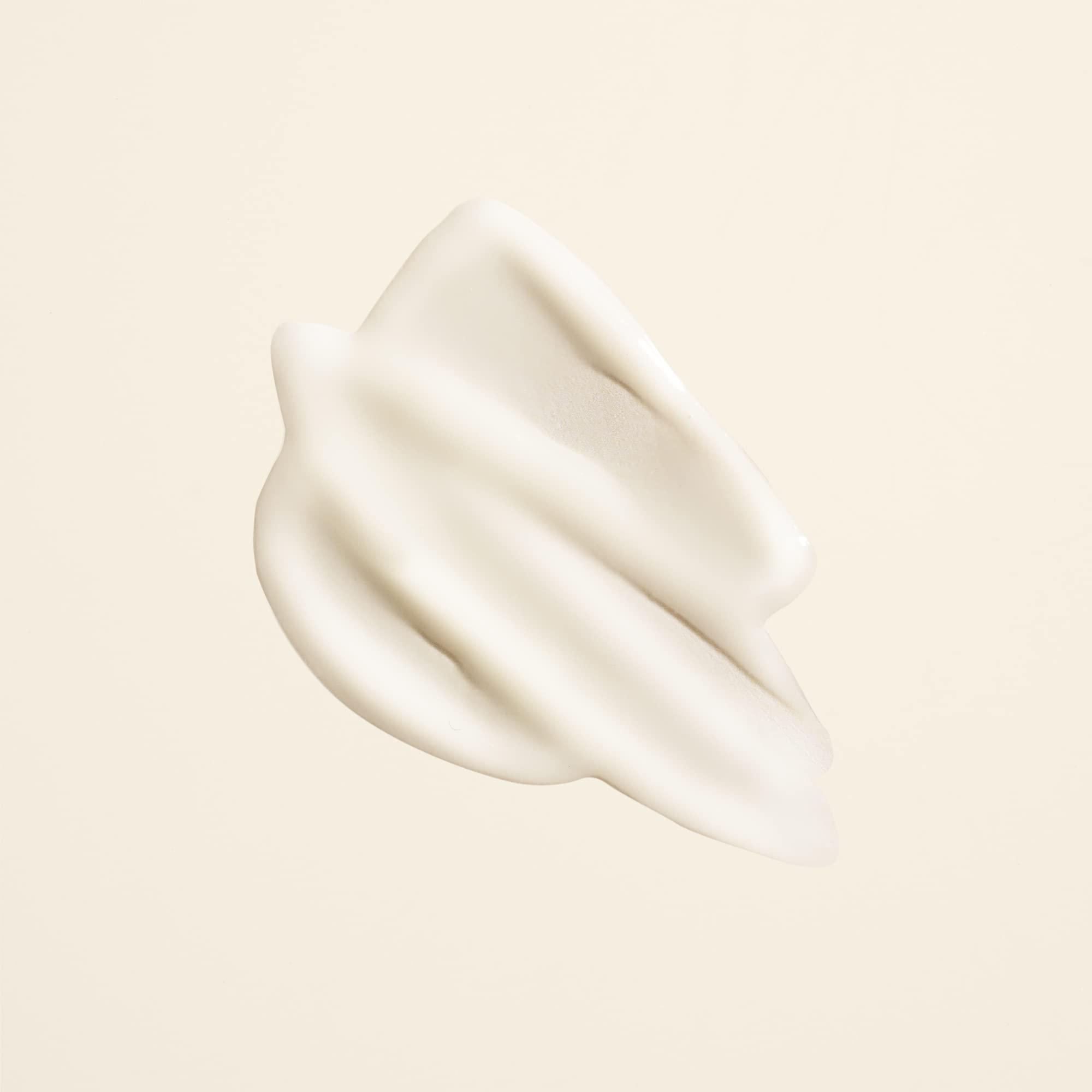 Closeup cap of Oribe Matte Waves Texture Lotion with pull-off design