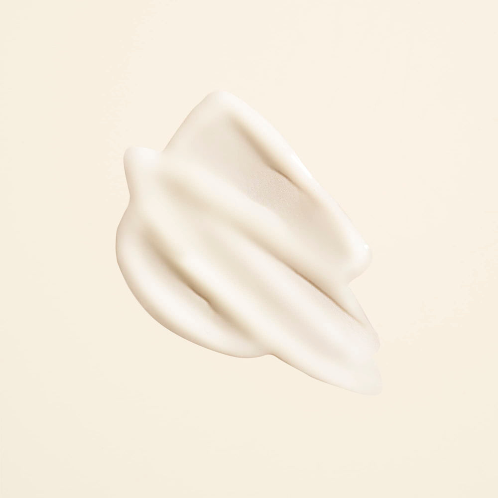 Closeup cap of Oribe Matte Waves Texture Lotion with pull-off design