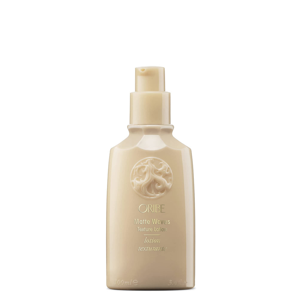 Hands applying Oribe Matte Waves Texture Lotion for even distribution and grip