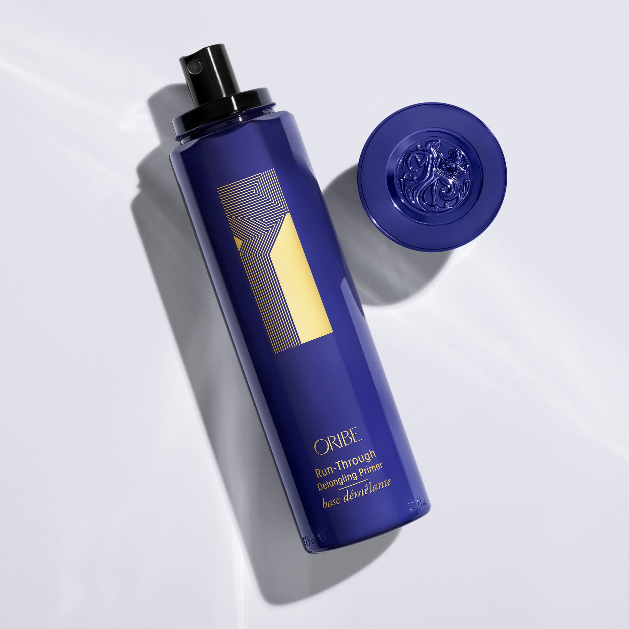 Oribe Run-Through Detangler shine closeup highlights cuticle sealing for shine.