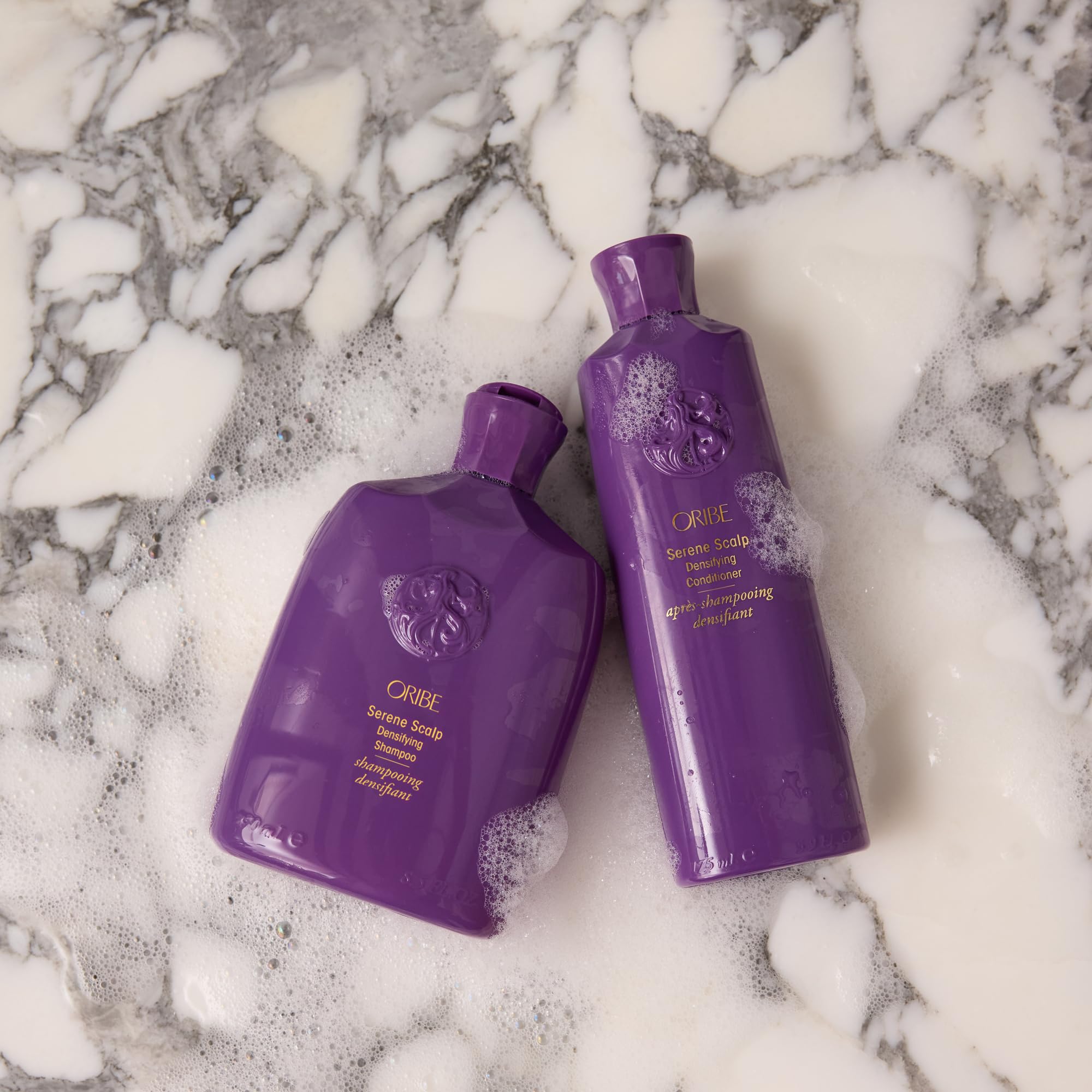 Detangling action demonstrated with Oribe Serene Scalp Densifying Conditioner on hair.