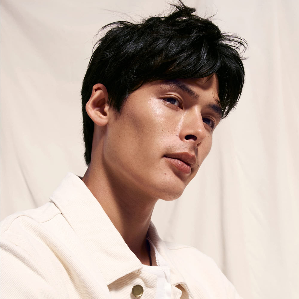 Oribe Serene Scalp Oil Control Shampoo application on damp hair demonstrates even distribution.
