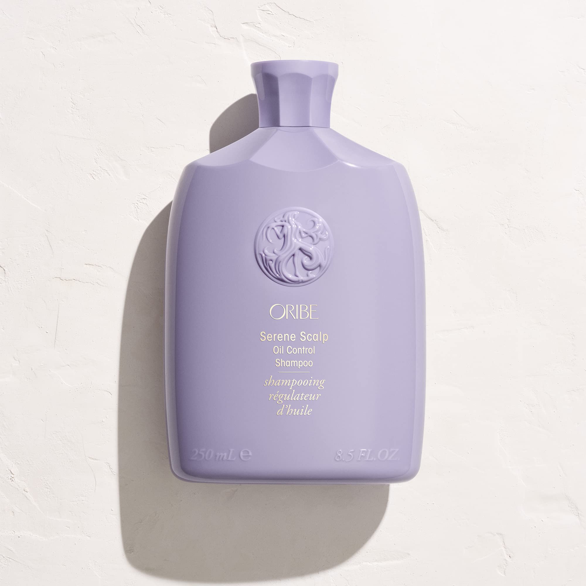 Oribe Serene Scalp Oil Control Shampoo dispensing top with lavender accent.