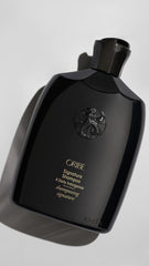 Oribe Signature Shampoo lather shown for detangling and smooth strands.