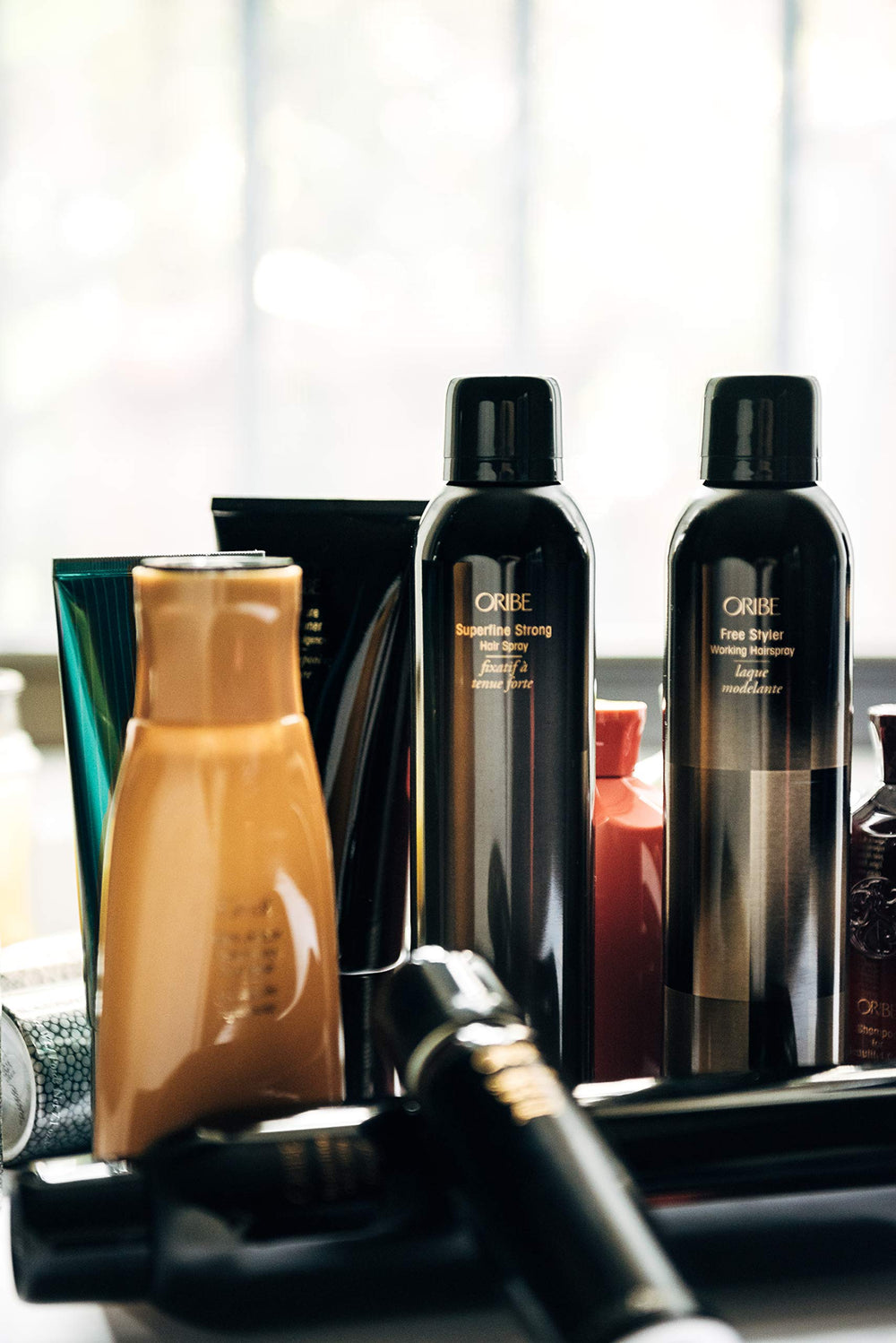 Oribe Superfine Strong Hair Spray on hair with lustrous finish and strong hold.