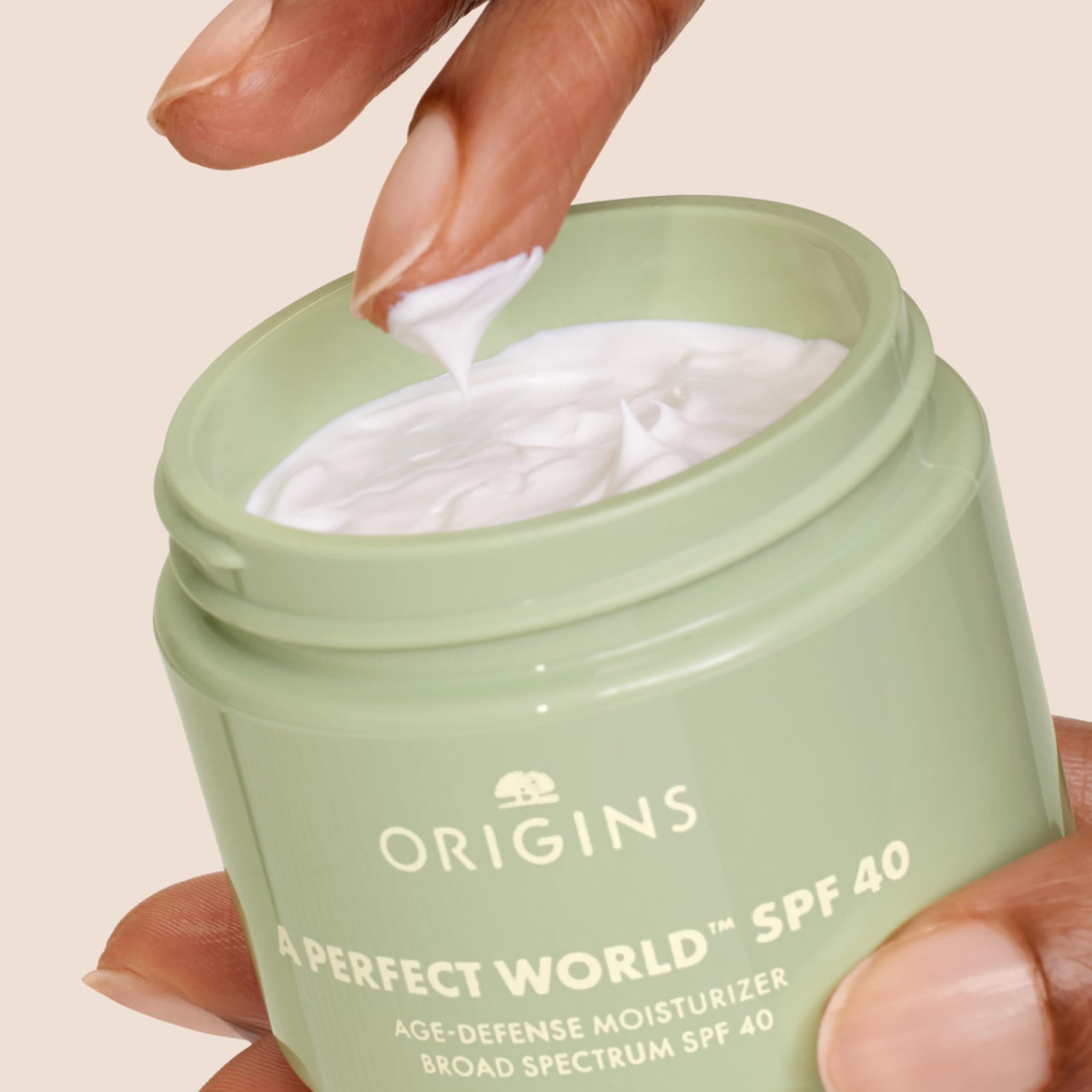 Origins A Perfect World moisturizer on hand demonstrates lightweight hydration for daily wear.