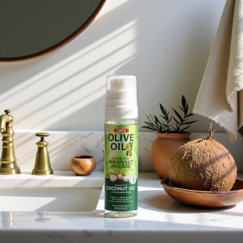 Applying ORS Olive Oil Wrap Mousse for defined, soft curls.
