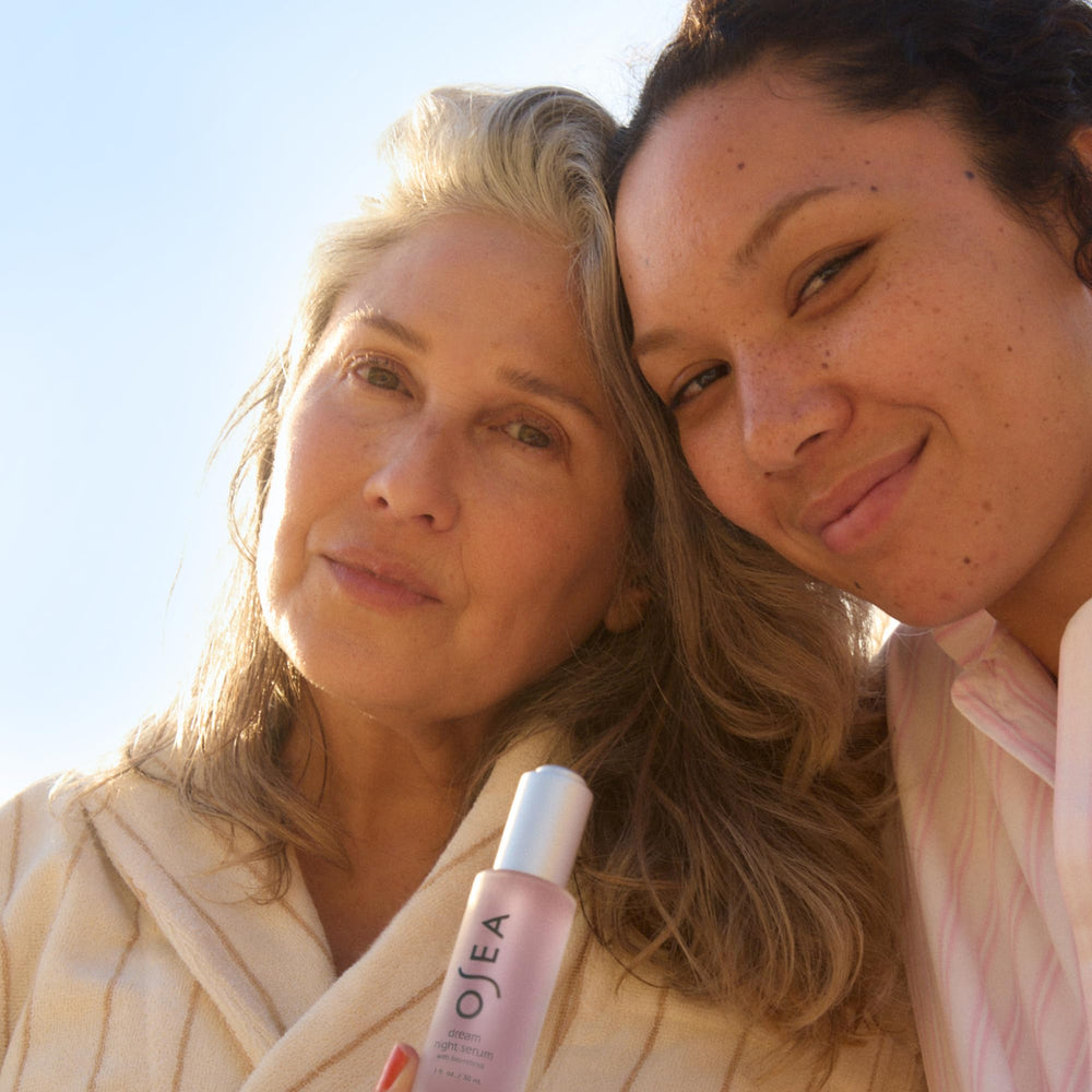 OSEA Dream Night Serum bottle with leaves in natural light for clean beauty.