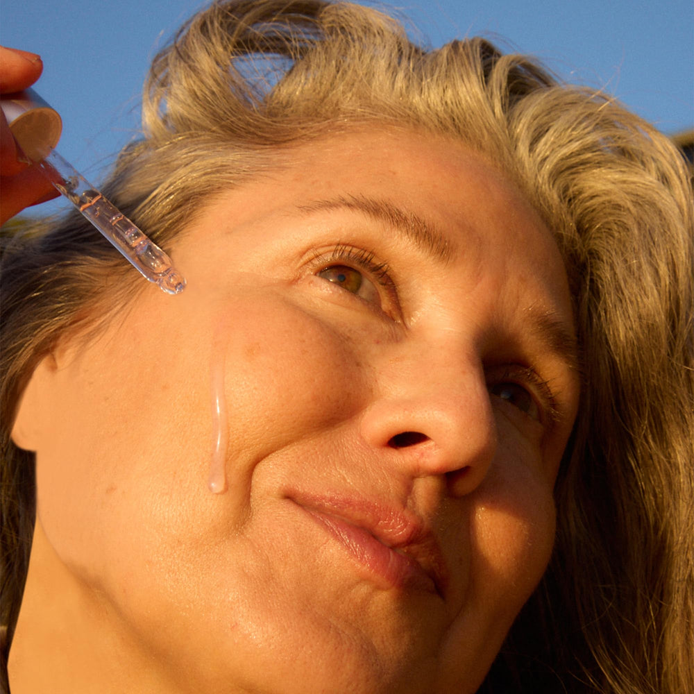 Close-up of the dropper dispensing OSEA Dream Night Serum for overnight nourishment.