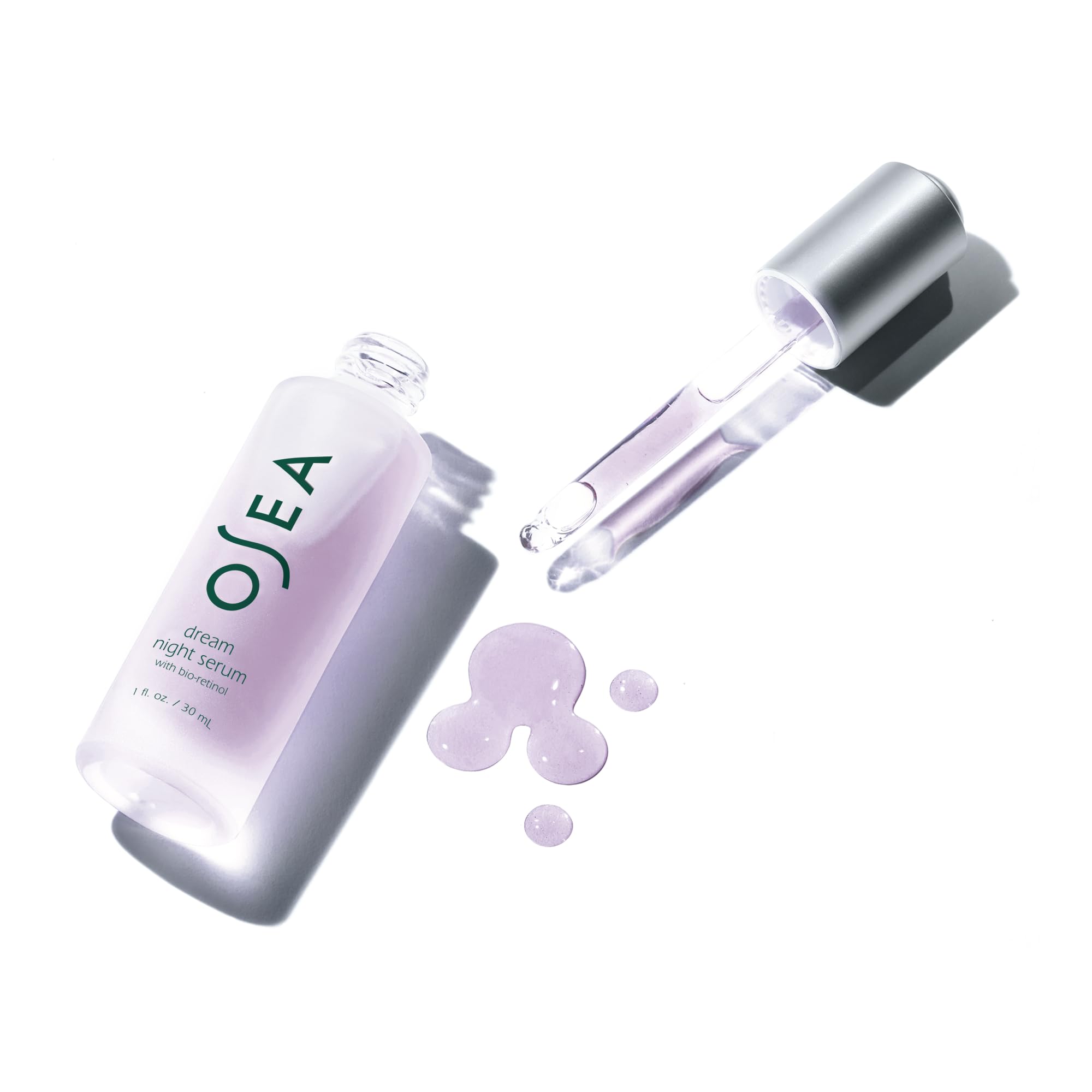 Applying OSEA Dream Night Serum to the hand during a night routine.