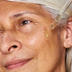 Dropper releasing the serum's hydrating formula from OSEA bottle