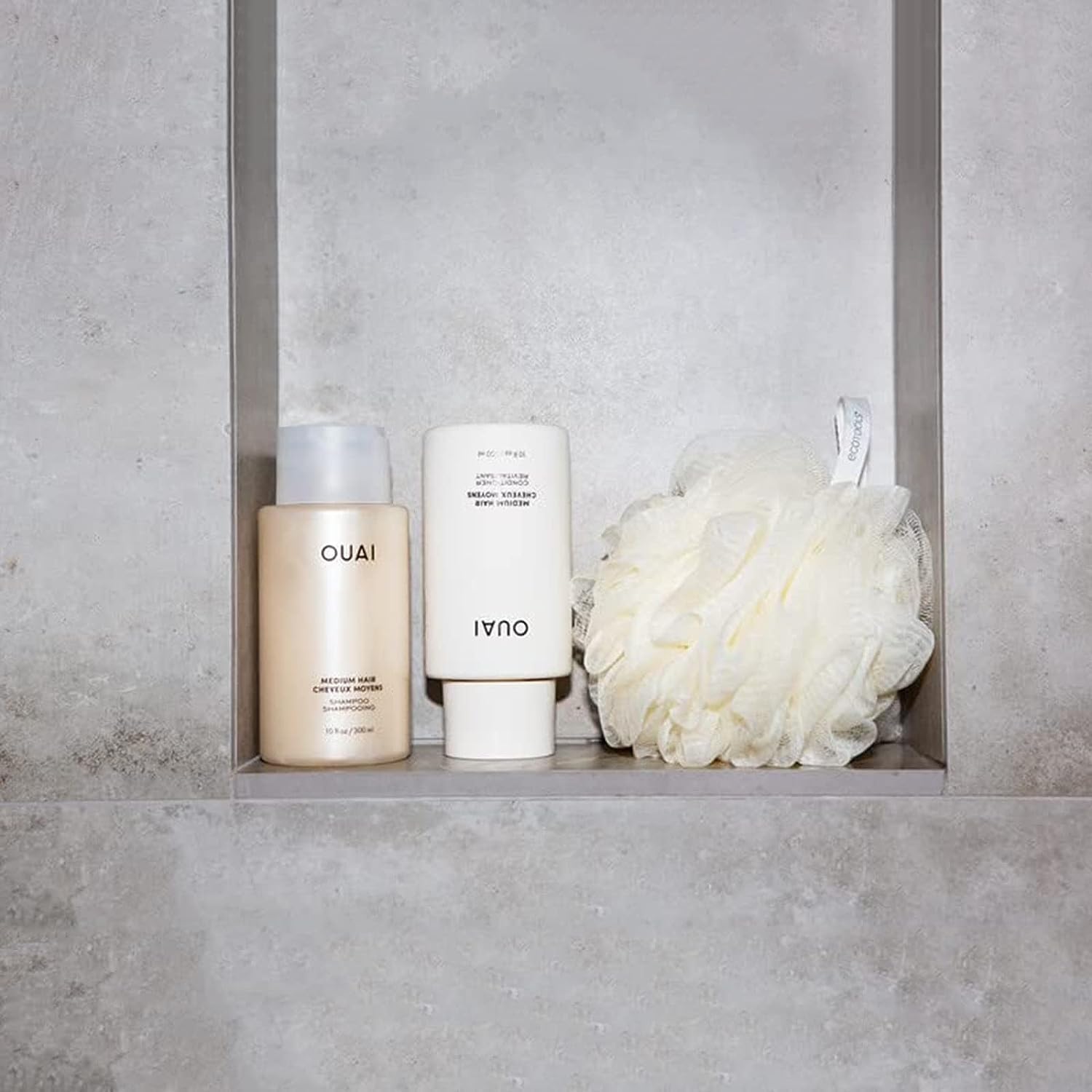 OUAI bathroom routine image with shampoo and conditioner