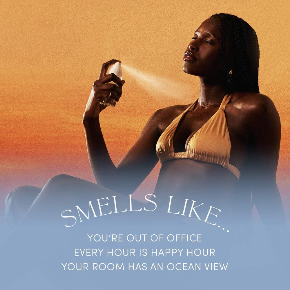 OUAI St. Barts sun-kissed spray on skin demonstrates tropical scent layering.