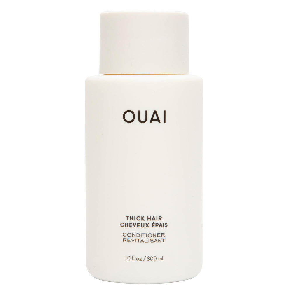 OUAI Thick Hair Conditioner bottle pour showing rich hydration for smooth strands