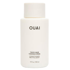 OUAI Thick Hair Conditioner bottle pour showing rich hydration for smooth strands
