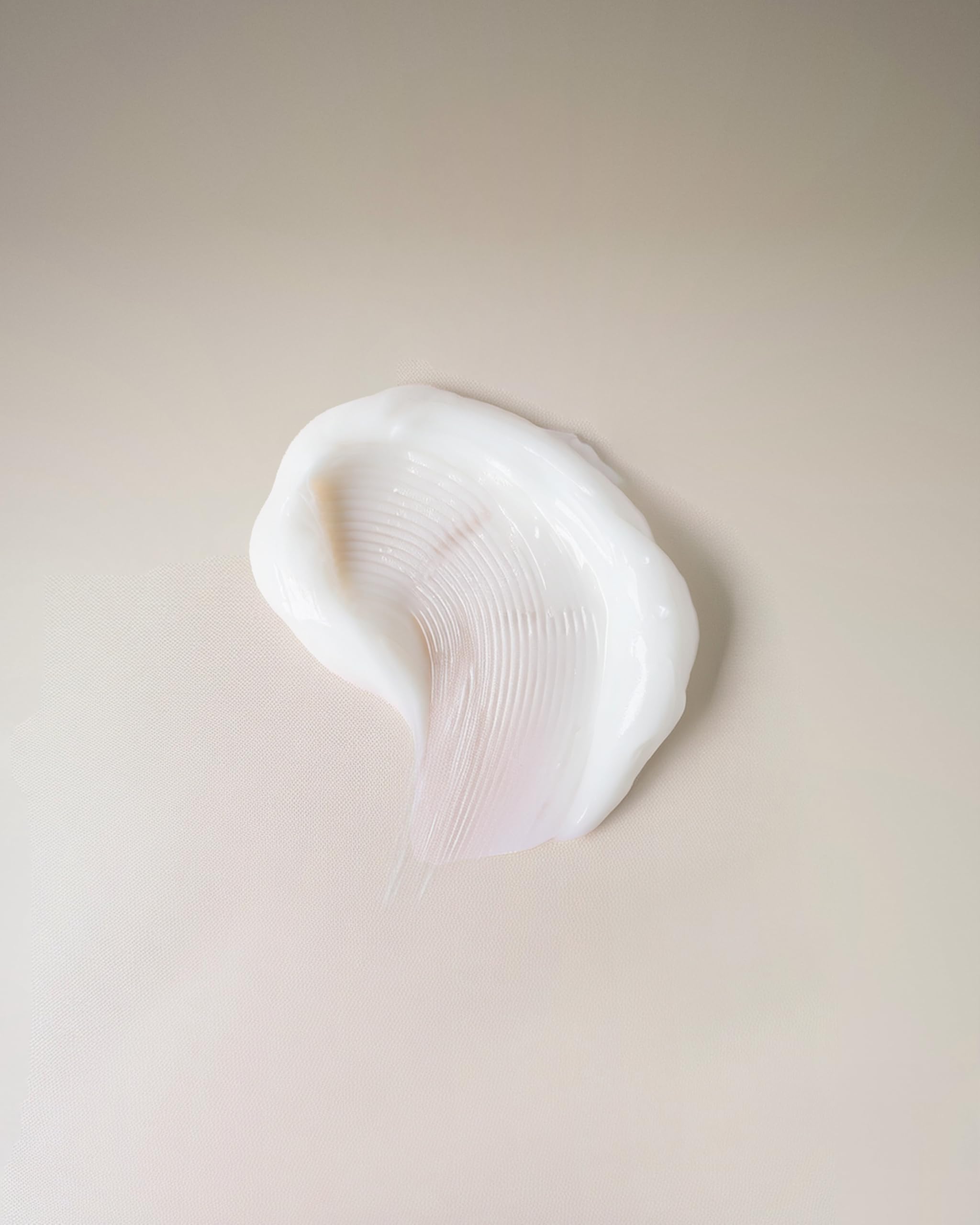 Close-up of Ouidad Curl Shaper cream dispense for quick styling